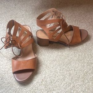 Brown laced up sandals with a heel